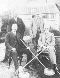 Four unidentified men with curling stones 